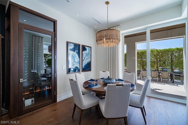 dining room featuring a chandelier and dark wood-type flooring