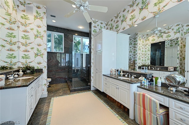 bathroom featuring double sink, oversized vanity, and ceiling fan