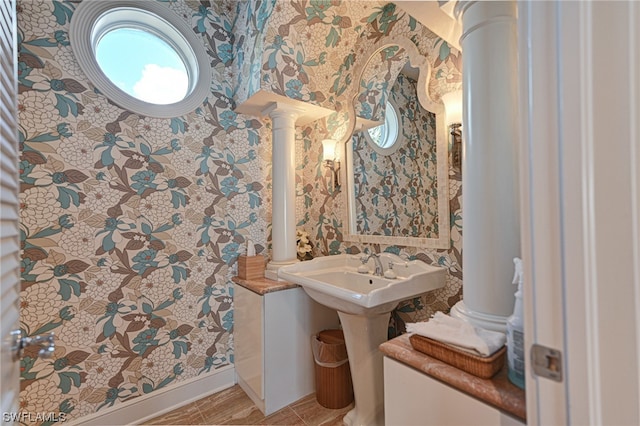 bathroom with tile flooring and ornate columns