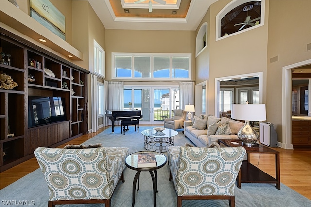 living room featuring light hardwood / wood-style floors and a high ceiling