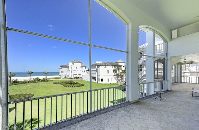 unfurnished sunroom with a water view