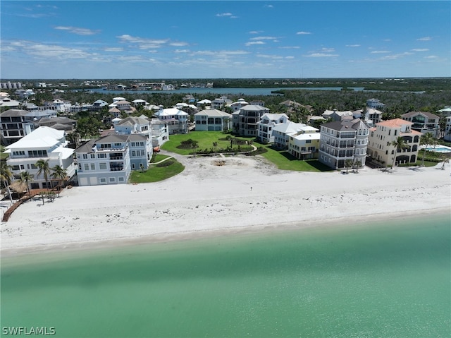 birds eye view of property with a beach view and a water view