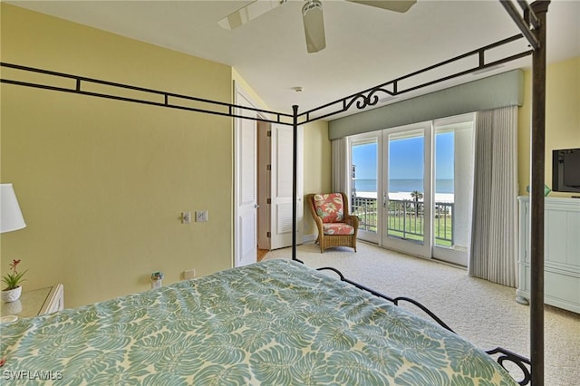 bedroom with access to exterior, ceiling fan, and carpet