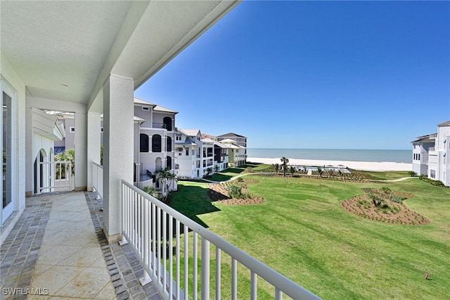 balcony with a beach view and a water view