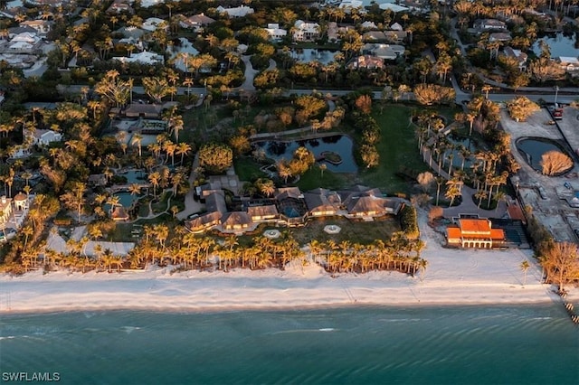 birds eye view of property with a view of the beach and a water view