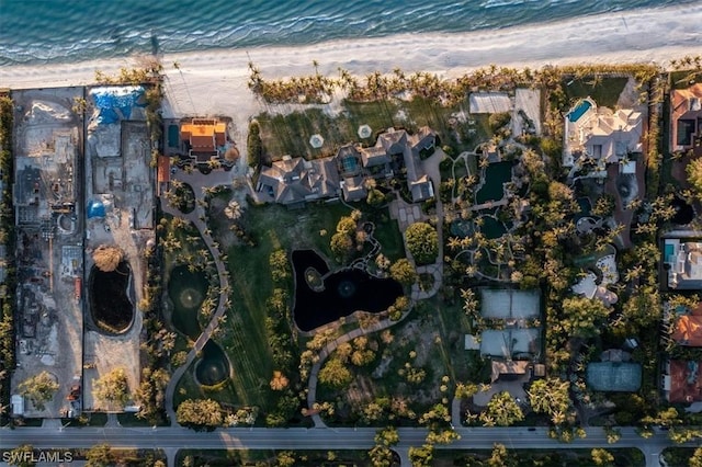 drone / aerial view featuring a water view and a view of the beach