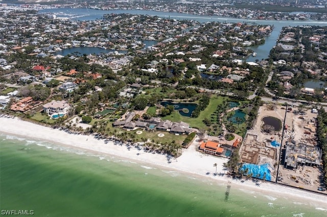 drone / aerial view featuring a water view and a beach view