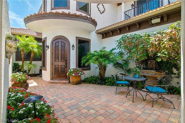 entrance to property with a patio area and a balcony