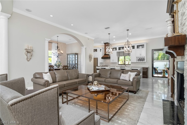 living room featuring a wealth of natural light, crown molding, and a premium fireplace