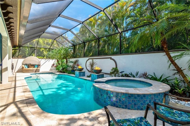 view of pool with a lanai and an in ground hot tub