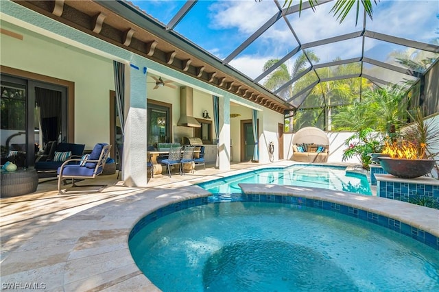 view of pool featuring a lanai, ceiling fan, and a patio area