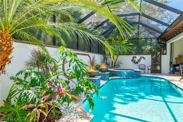 view of pool featuring an in ground hot tub, a patio, and a lanai