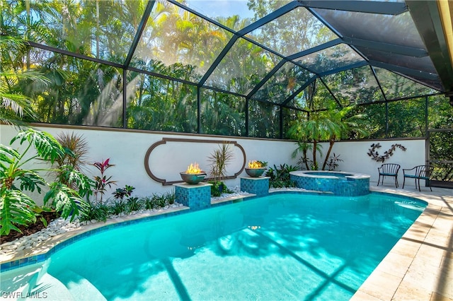 view of pool with glass enclosure, an in ground hot tub, and a patio