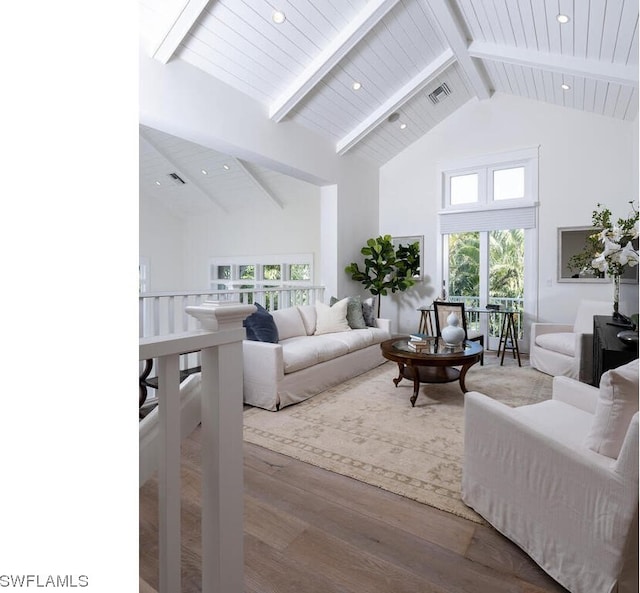 living room with beam ceiling, high vaulted ceiling, hardwood / wood-style floors, and a wealth of natural light