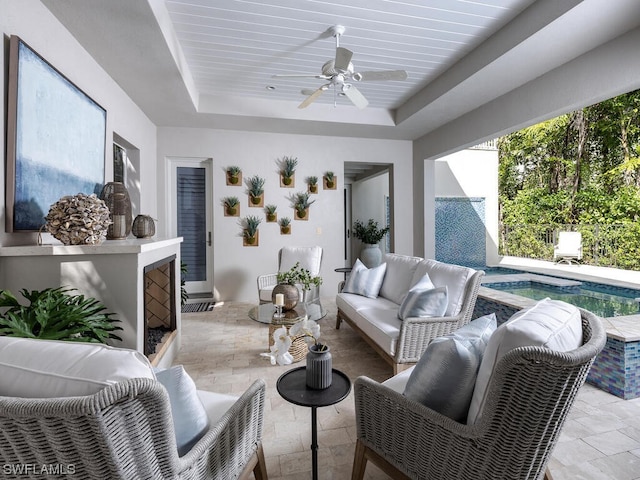 interior space featuring ceiling fan and a tray ceiling