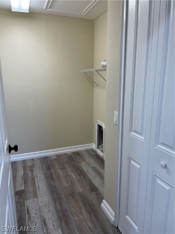 washroom featuring laundry area, dark wood-style flooring, and baseboards