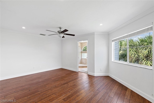 spare room with crown molding, dark hardwood / wood-style floors, ceiling fan, and a wealth of natural light