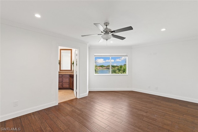 spare room featuring crown molding, ceiling fan, and dark hardwood / wood-style flooring