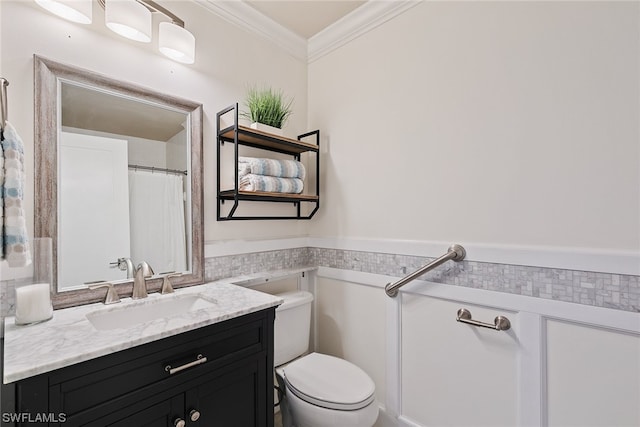 bathroom featuring toilet, ornamental molding, and vanity