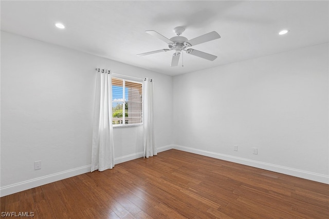 empty room featuring dark hardwood / wood-style floors and ceiling fan