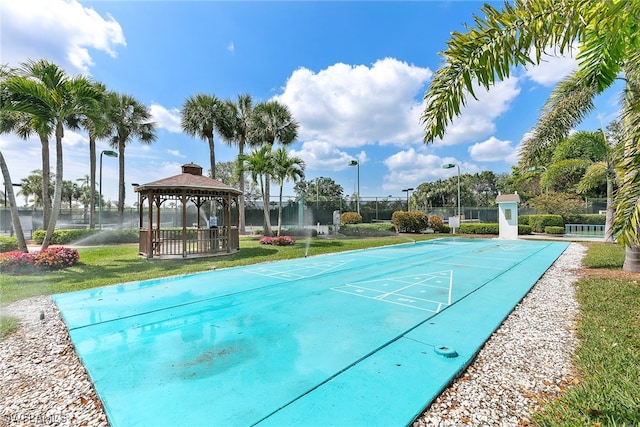 view of swimming pool with a yard and a gazebo