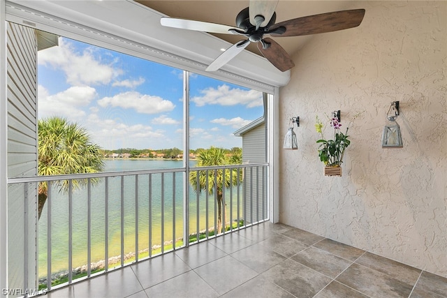 interior space featuring a water view and ceiling fan