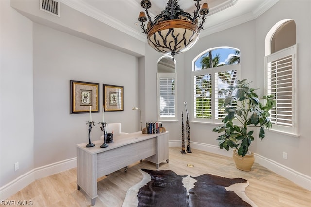 office space featuring light hardwood / wood-style floors and ornamental molding