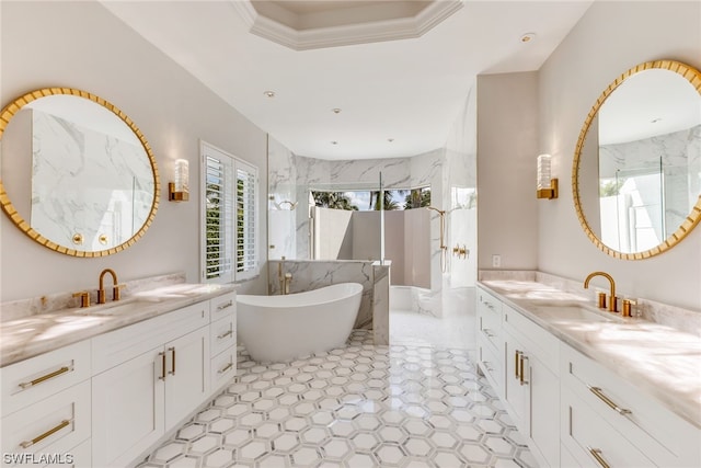 bathroom featuring ornamental molding, vanity, and a bathing tub