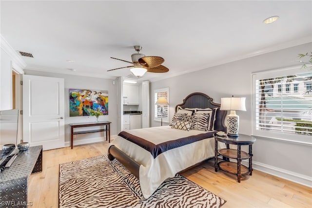 bedroom with ceiling fan, light hardwood / wood-style floors, and crown molding