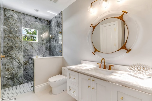 bathroom featuring tiled shower, tile patterned floors, vanity, and toilet