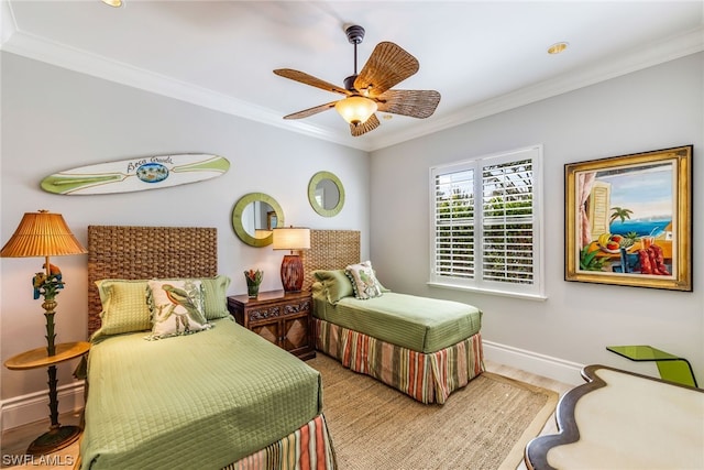 bedroom with ceiling fan, hardwood / wood-style floors, and ornamental molding