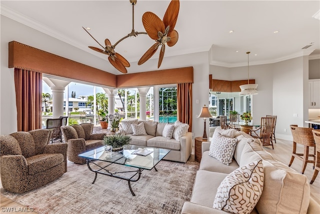 living room featuring ceiling fan, light hardwood / wood-style floors, and crown molding