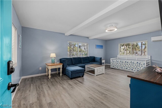 living room with a wall mounted air conditioner, light wood-type flooring, and beam ceiling