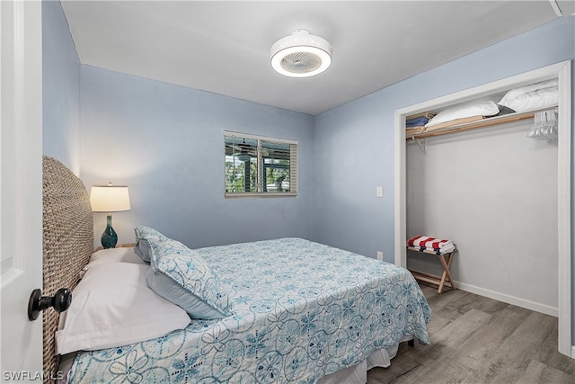 bedroom with a closet and light hardwood / wood-style flooring