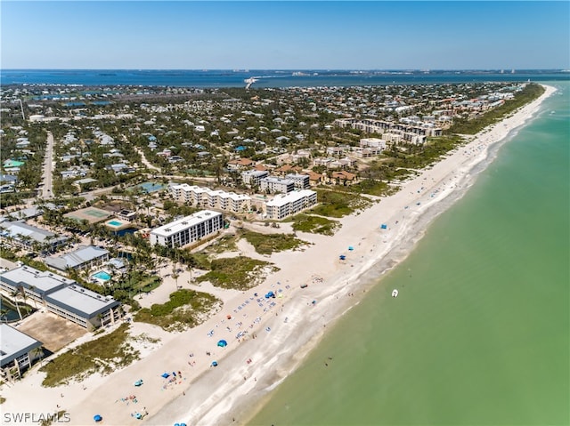 drone / aerial view featuring a water view and a view of the beach