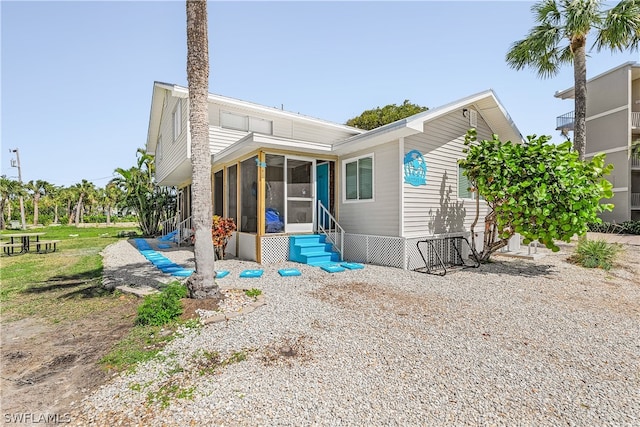 back of property featuring a sunroom