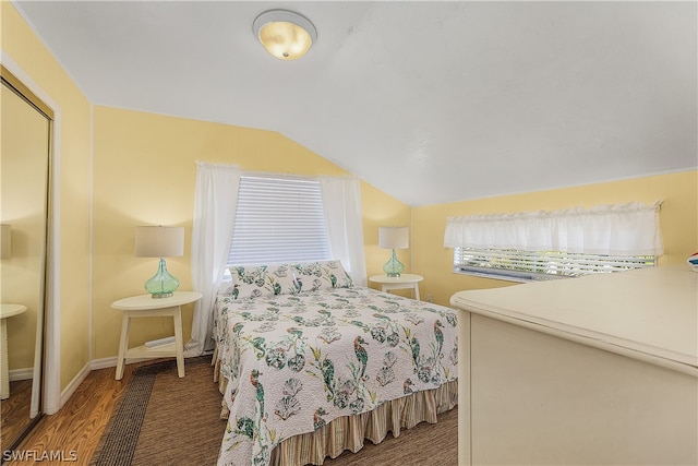 bedroom with dark hardwood / wood-style flooring and vaulted ceiling