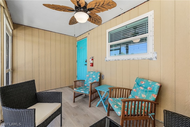 living area with ceiling fan and light hardwood / wood-style flooring