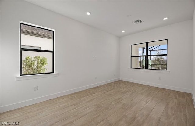 unfurnished room with light wood-type flooring