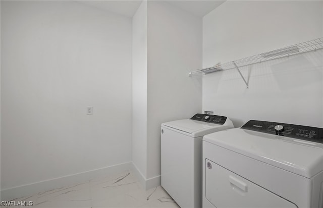 clothes washing area featuring separate washer and dryer and light tile floors