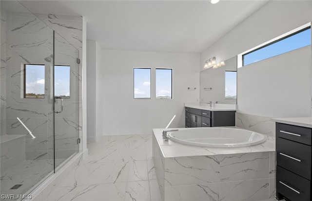 bathroom featuring tile flooring, vanity with extensive cabinet space, and separate shower and tub