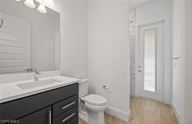 bathroom featuring hardwood / wood-style flooring, vanity, and toilet