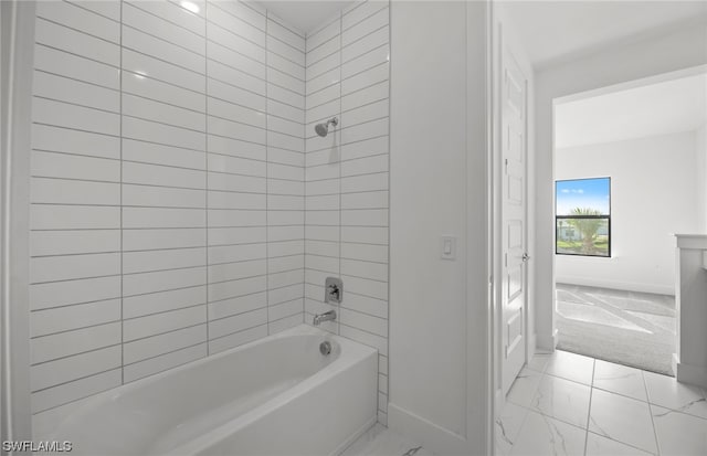 bathroom with tiled shower / bath and tile flooring