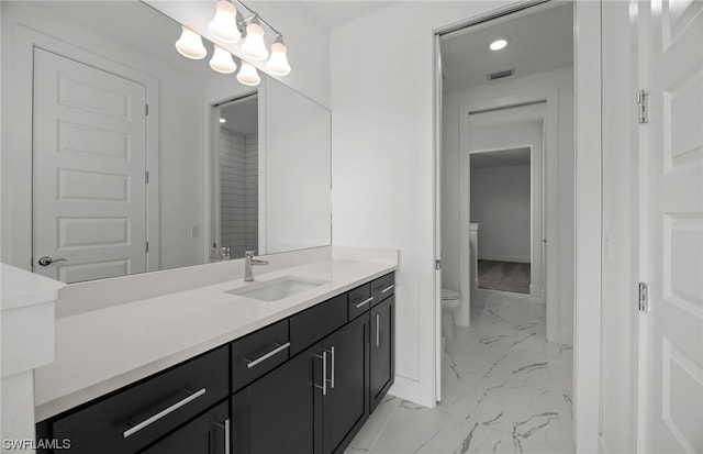 bathroom featuring vanity, tile floors, and toilet