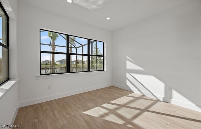 spare room with light hardwood / wood-style flooring