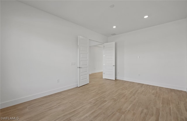 spare room with light wood-type flooring