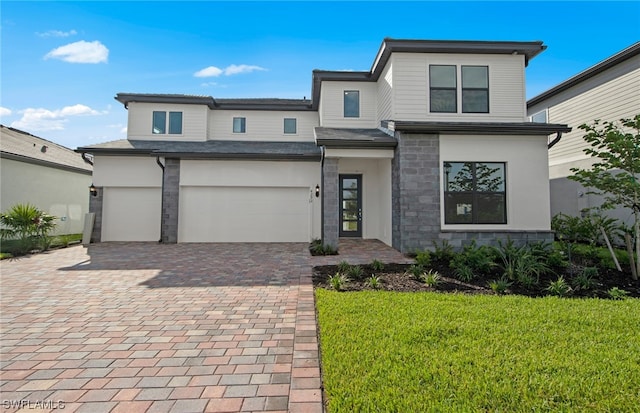 view of front of property with a garage and a front yard