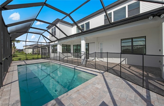 view of swimming pool featuring a lanai and a patio