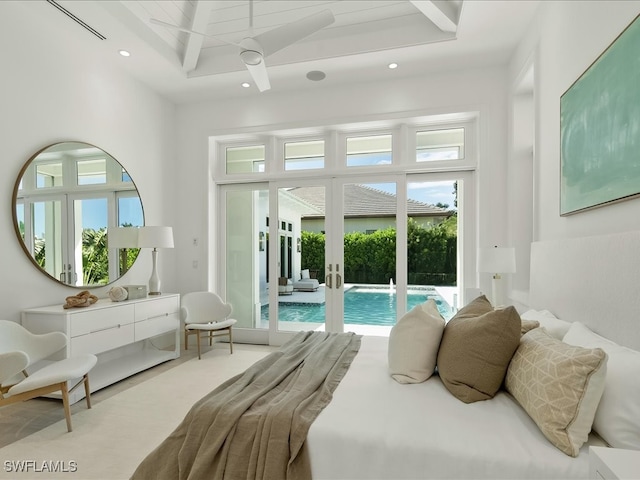 bedroom with access to exterior, french doors, a towering ceiling, and multiple windows