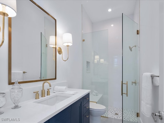 bathroom with tile patterned flooring, vanity, toilet, and a shower with shower door